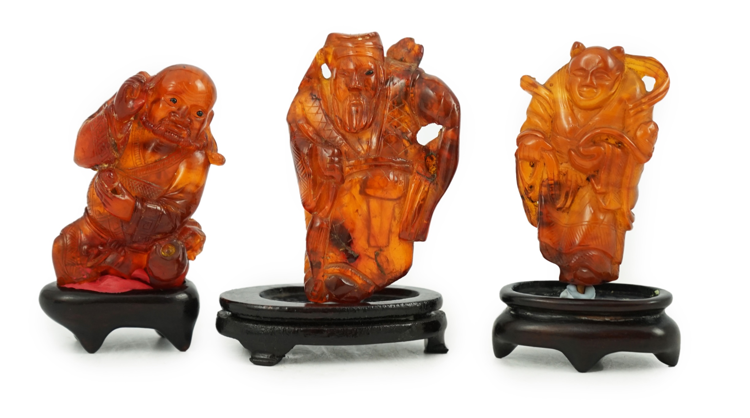 Three Chinese amber figures of immortals, 19th century